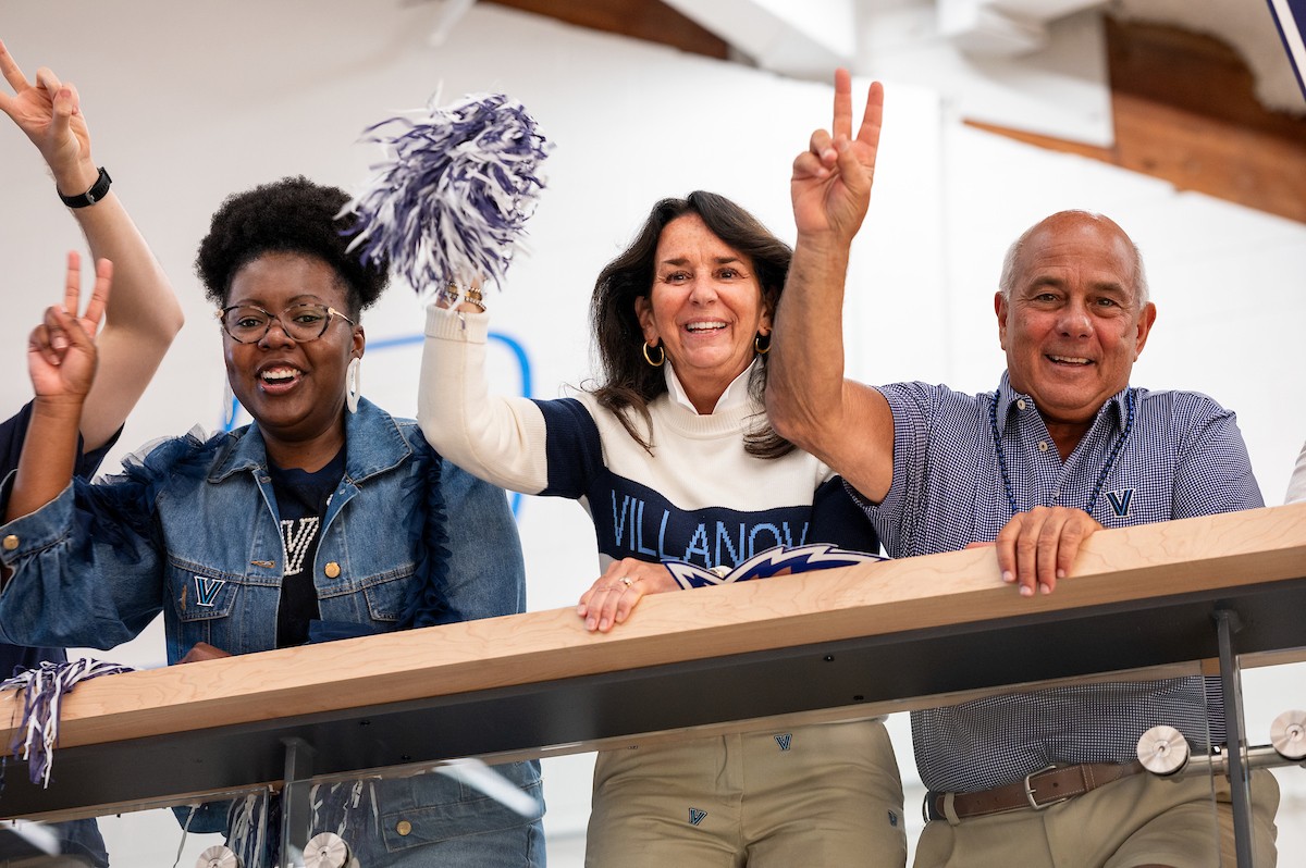 Two women alumni and one man in the Pavilion