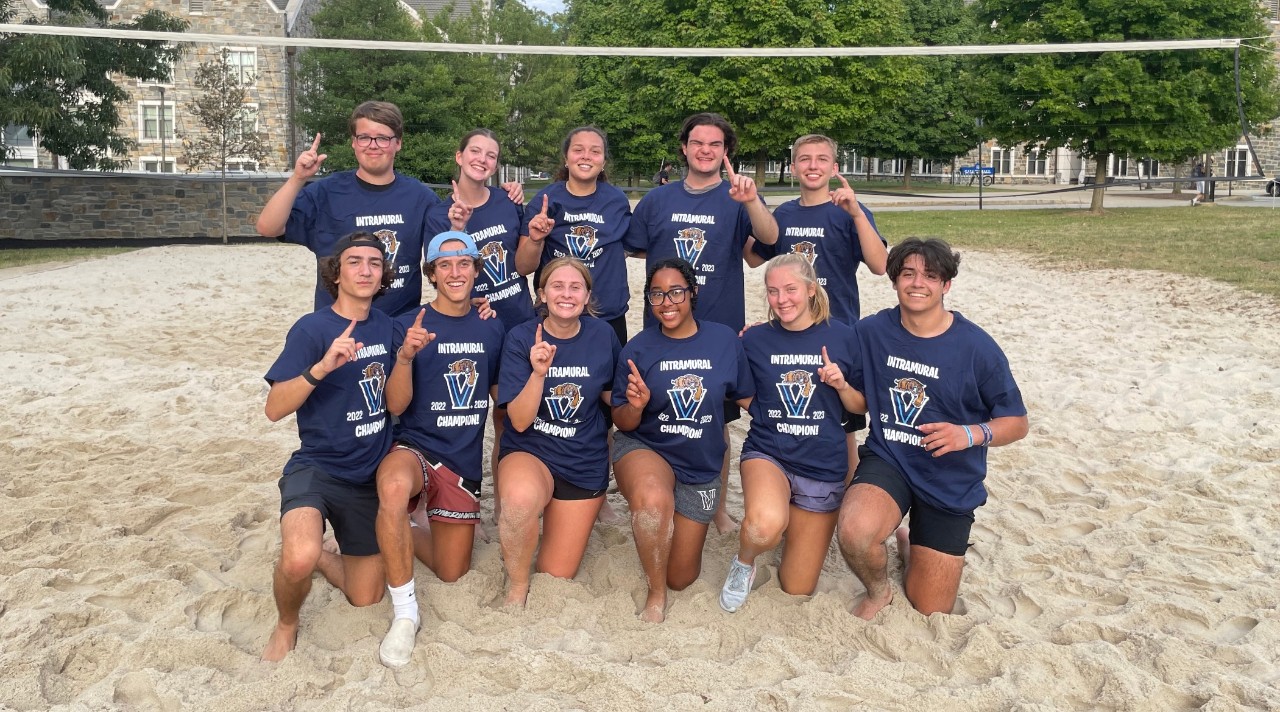 Students posing for sand volleyball champion photo