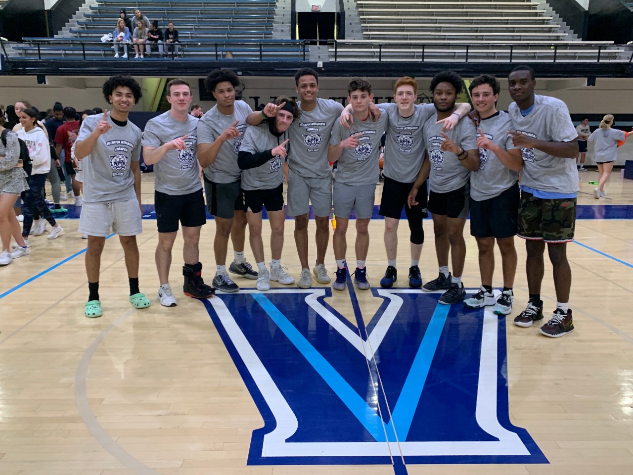 Male students posing for basketball champion photo
