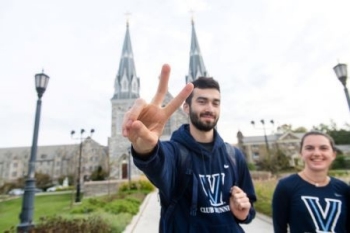 Students running in front of the St. Thomas of Villanova Church