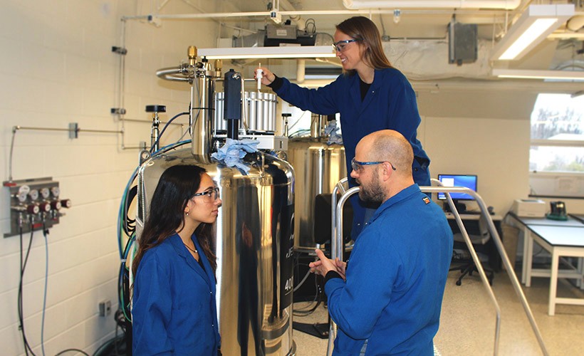 image of a professor and two students in the lab.