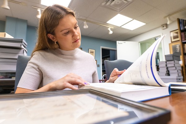Female student reading textbook