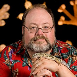 Aaron Bauer holds a lizard.