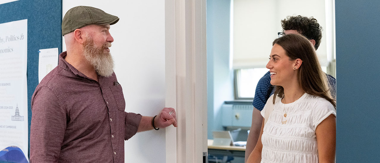 Professor and student speaking in hallway