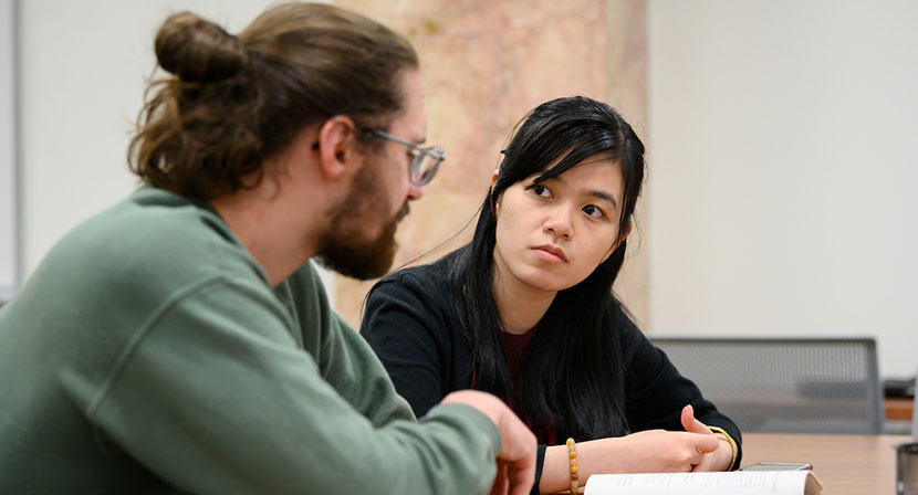 Tutor and student speaking at a table