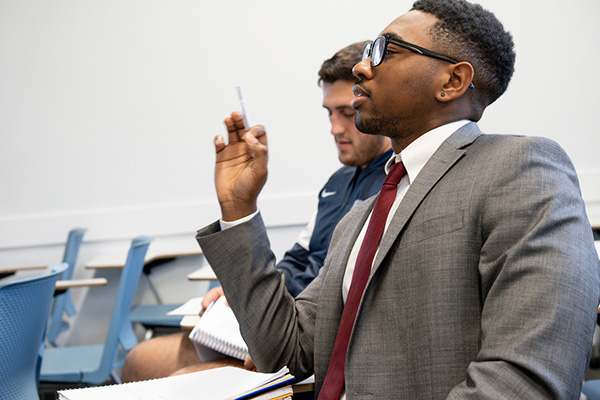 Student wearing a suit speaks.