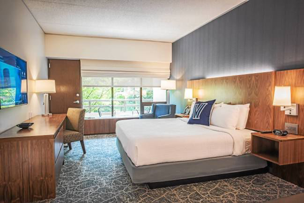 A hotel bed and desk