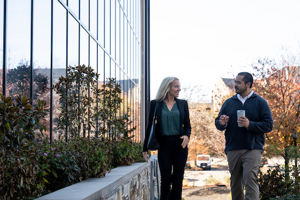 two people talking and walking outside