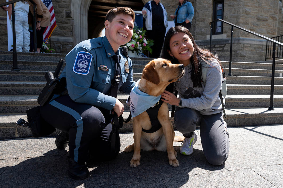 Taffy posing with her owner and a student