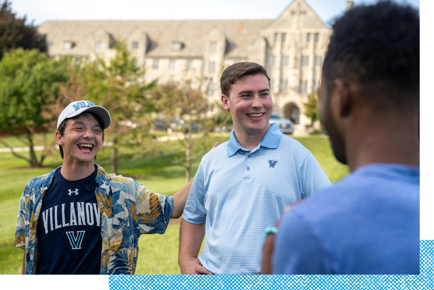 Students smiling and talking on campus.