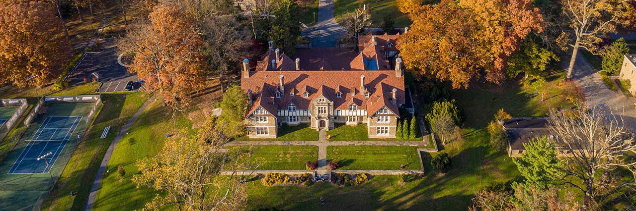 Aerial view of Cabrini’s campus in the fall, with colorful autumn foliage surrounding the buildings.